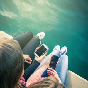 People using Cell phones on a boat