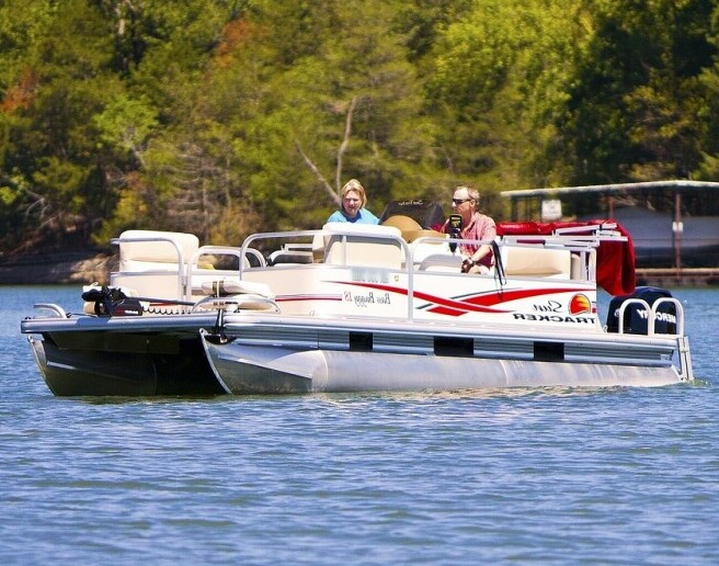Friends laughing and enjoying a sunset ride on a pontoon boat