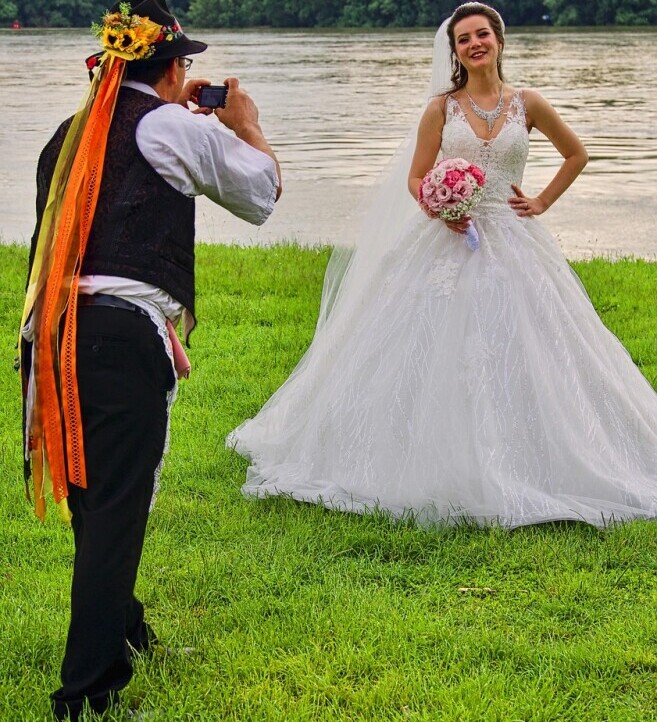 taking wedding photos by a lake