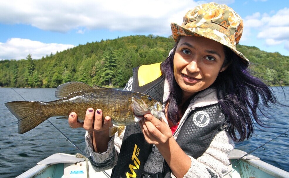 fisherman with caught bass fish